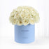 Cream roses in pastel blue box reading "It&