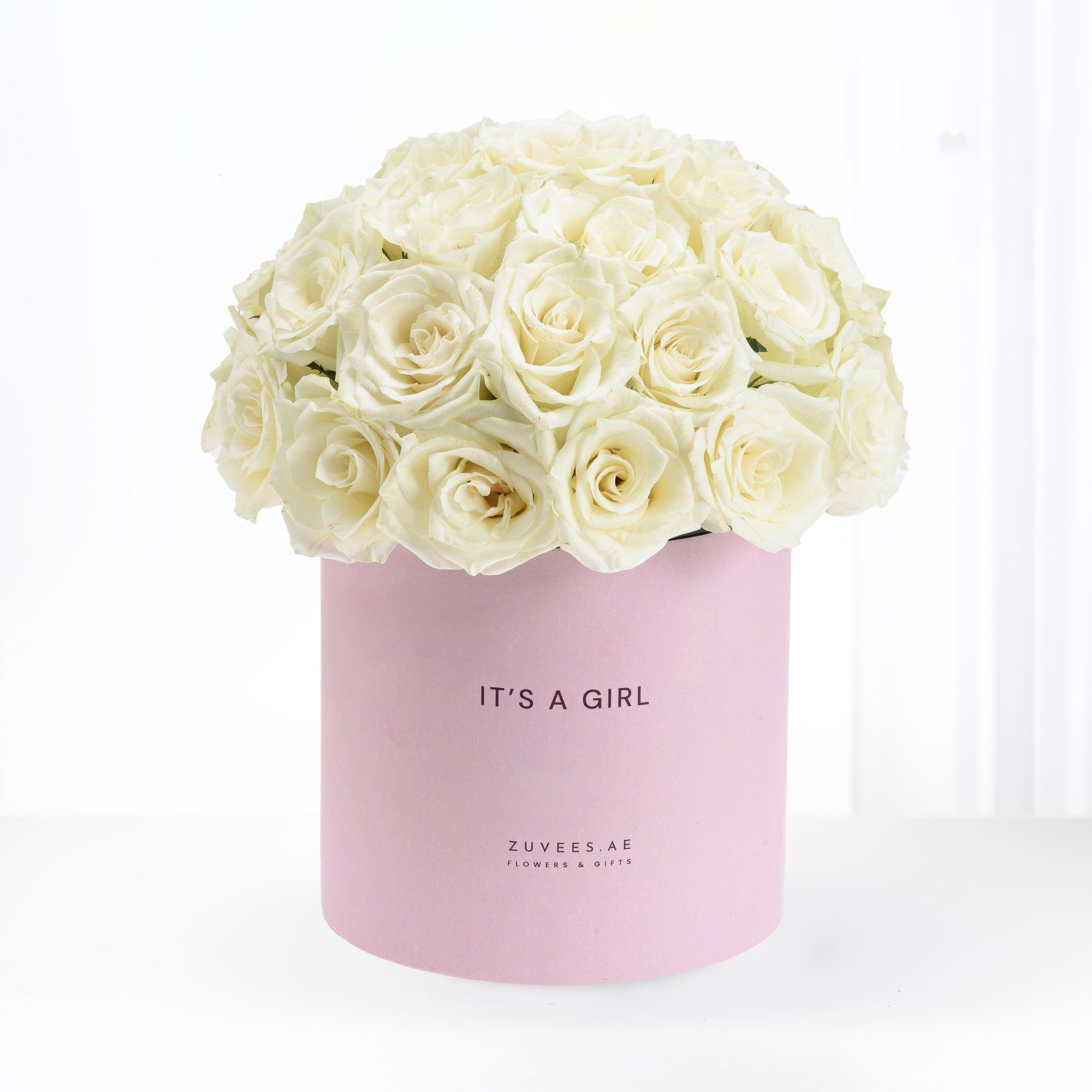 Soft cream roses in pastel pink box reading "It&