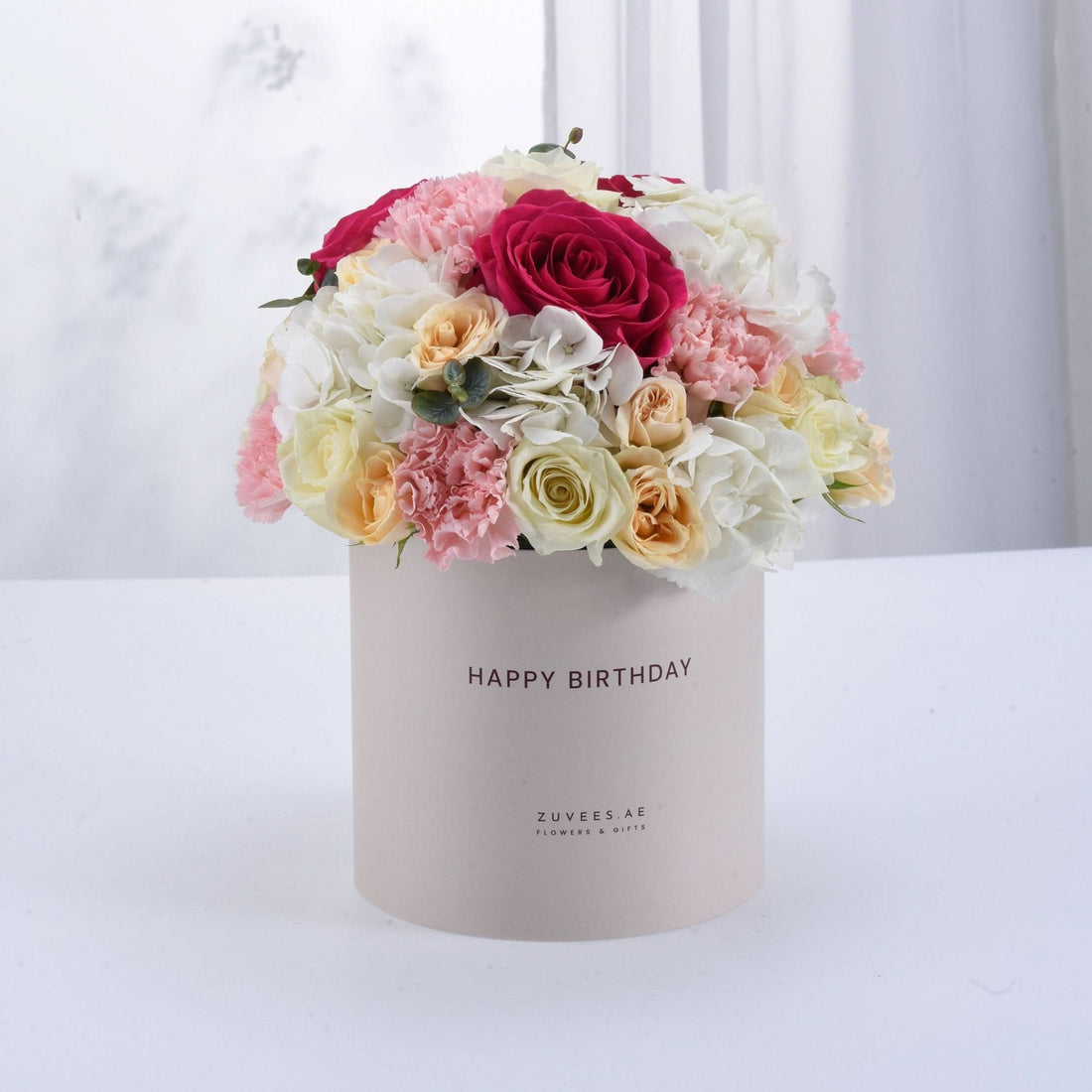 Pastel pink, white, and peach floral arrangement in a "Happy Birthday" box.