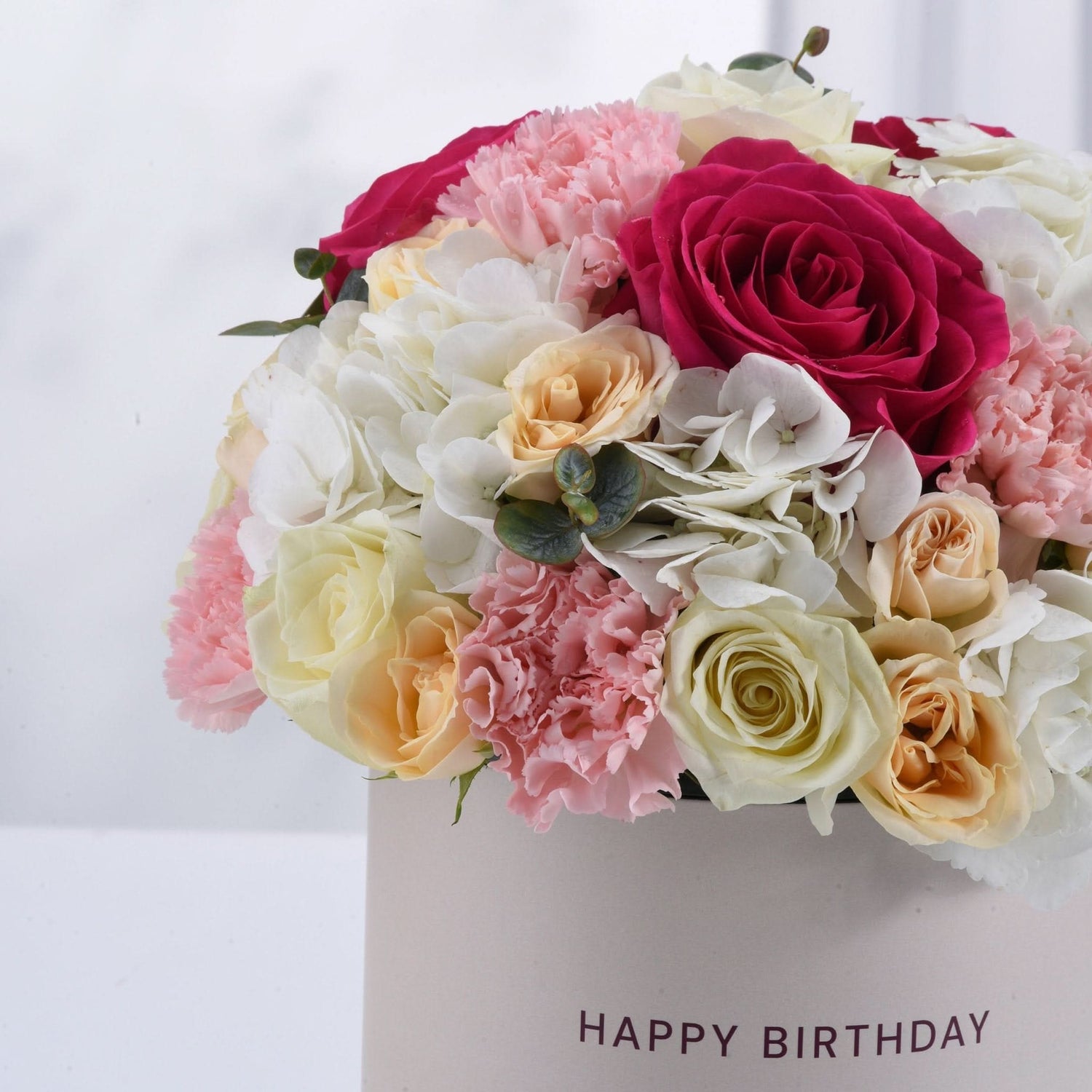 Vibrant pink, white, and peach roses &amp; carnations in "Happy Birthday" box.
