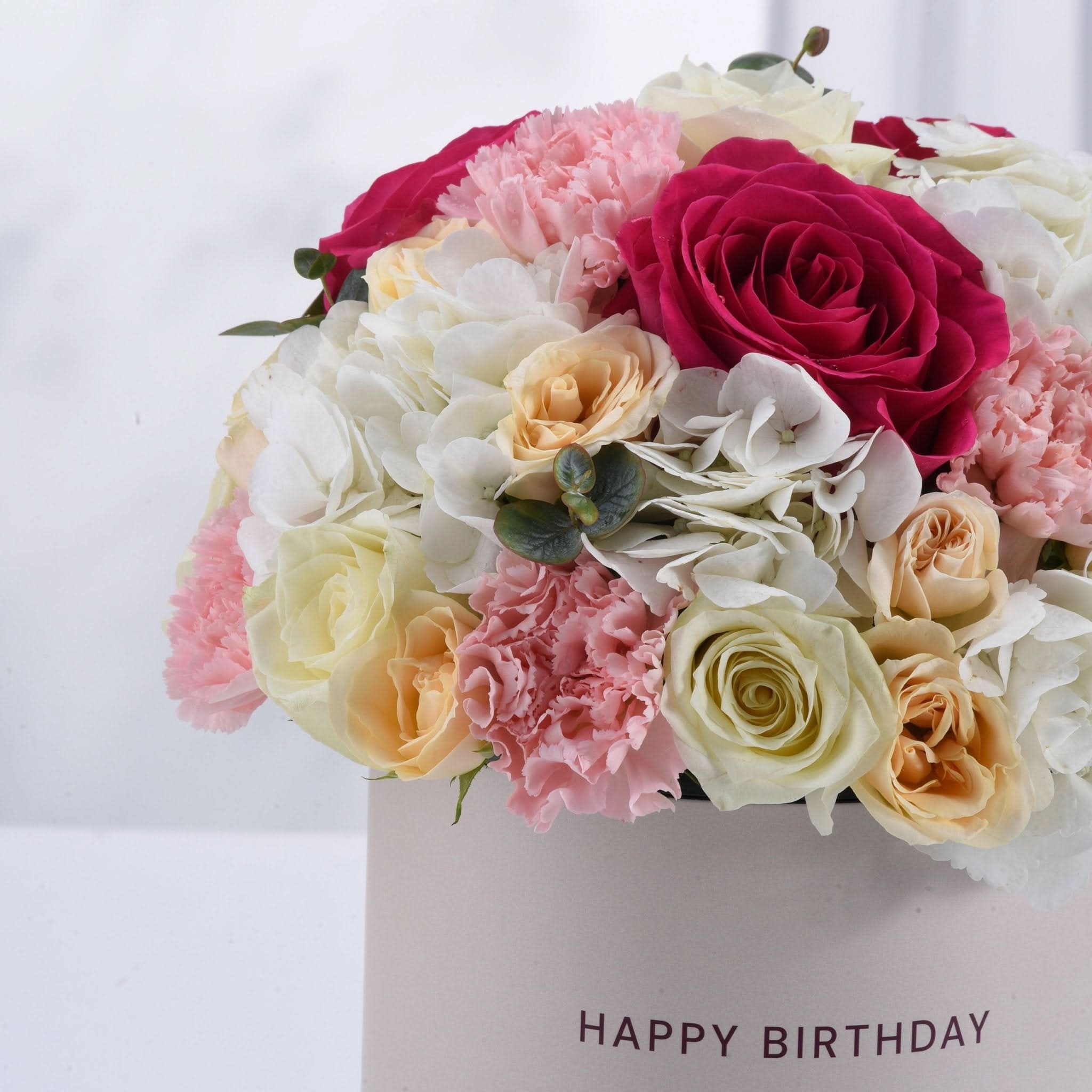 Vibrant pink, white, and peach roses &amp; carnations in "Happy Birthday" box.