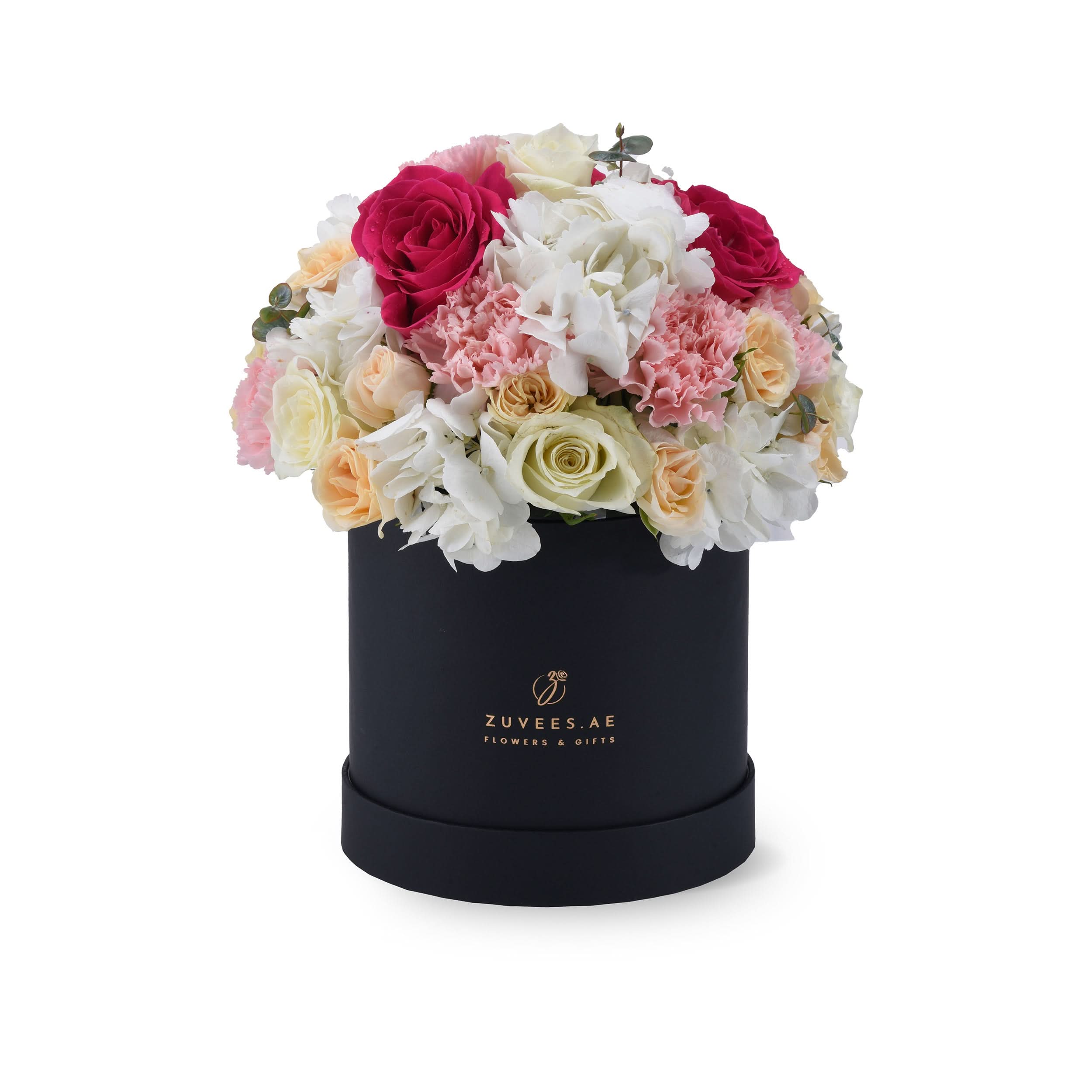 Elegant black box filled with vibrant pink, white, and cream roses and hydrangeas.