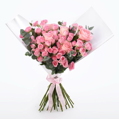 Soft pink roses and eucalyptus wrapped in clear cellophane with a matching ribbon.