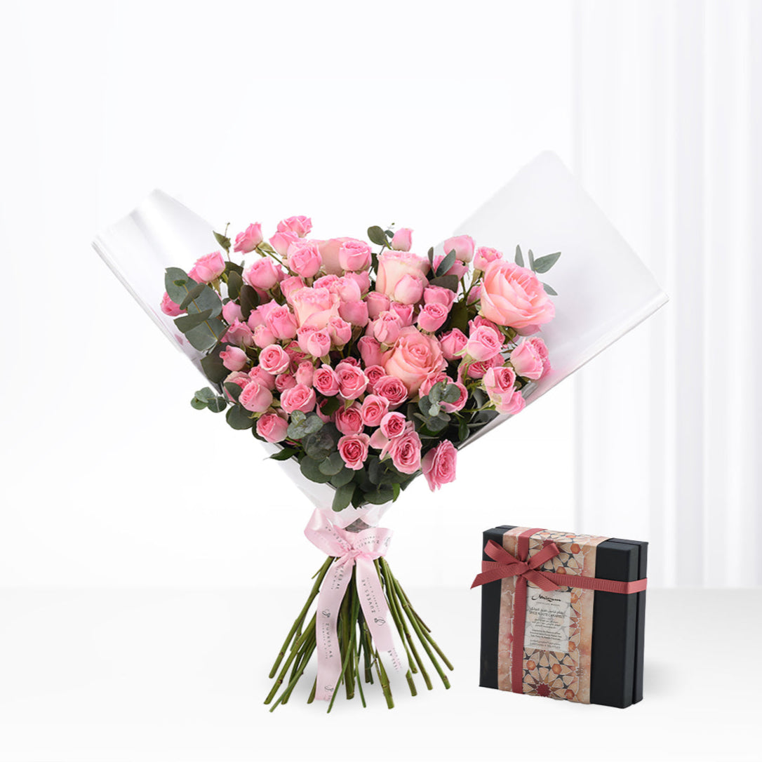 Soft pink roses in clear wrap, paired with elegant gift box.