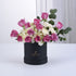 Elegant pink roses and white hydrangeas in matte black gift box.