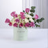 Pastel mint box holds vibrant pink roses, white hydrangeas, and eucalyptus for get-well-soon gift.