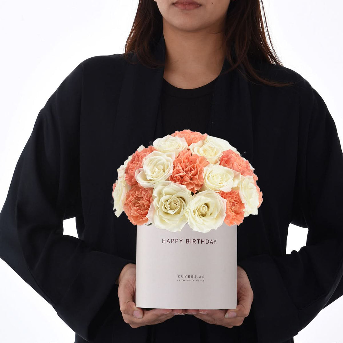 White box holds coral roses and carnations, “Happy Birthday” printed.