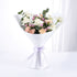 Soft pastel roses and eucalyptus wrapped in white paper with lavender ribbon.