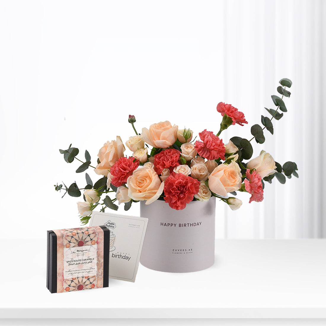 Pastel peach roses and red carnations in gray "Happy Birthday" vase, paired with caramel gift box.