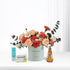 Pastel roses and carnations in mint vase with honey, throat lozenges, and electrolyte for recovery.