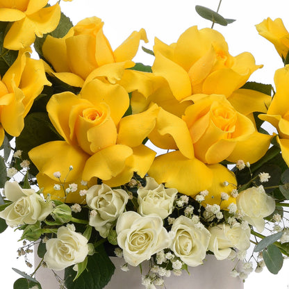 Vibrant yellow roses with white accents, dewdrops, and lush greenery.