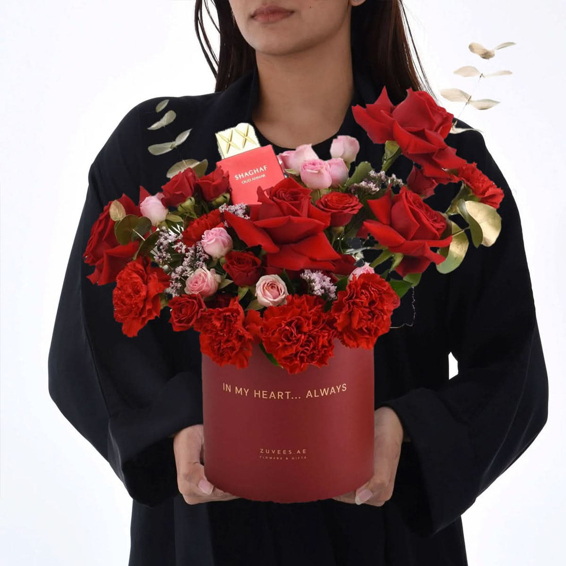 Red rose and carnation bouquet in branded box with perfume gift.