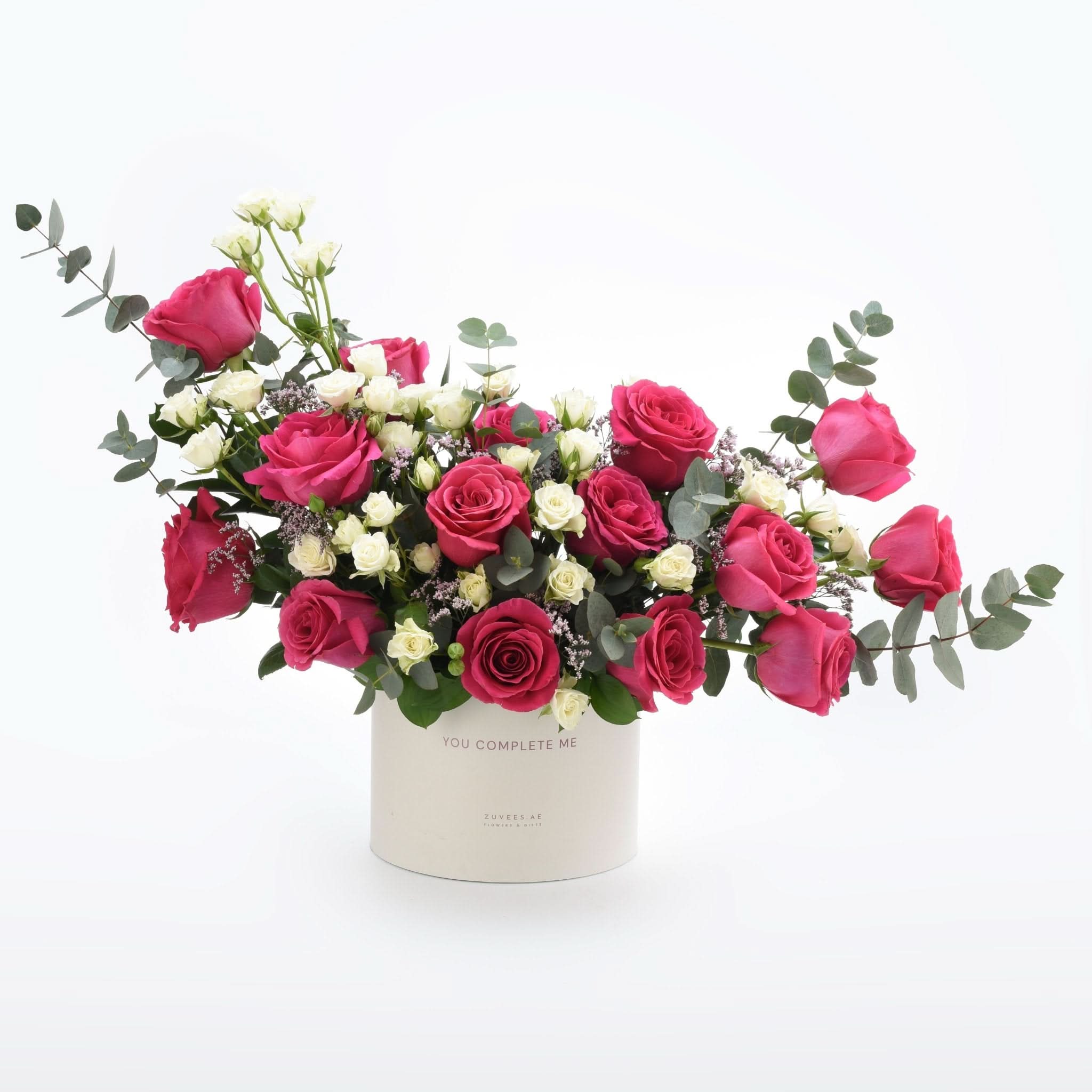 Vibrant pink and white roses in a "You Complete Me" gift box.
