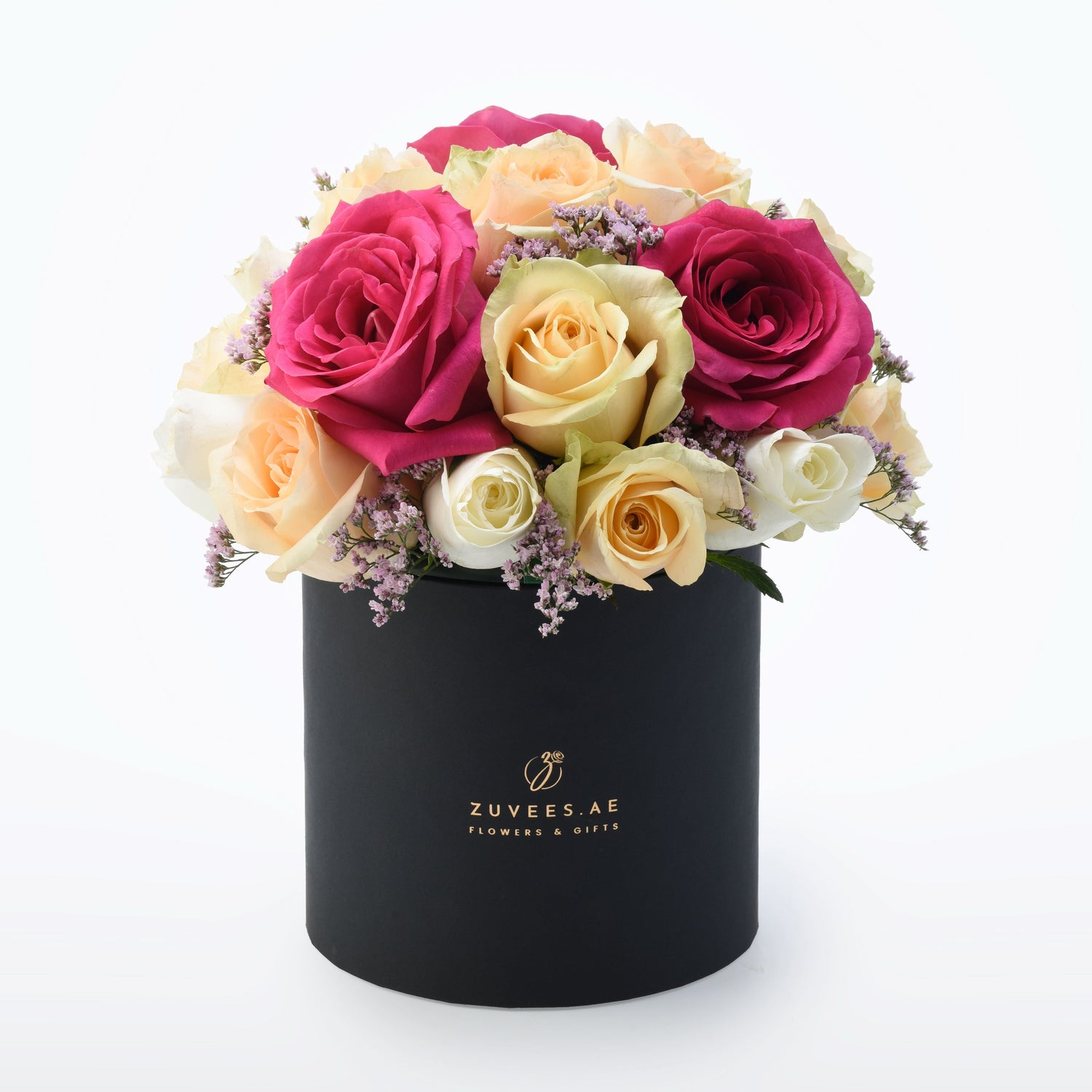 Vibrant pink, peach, and cream roses nestled in a sleek black hat box.
