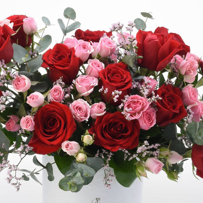 Vibrant red and pink roses with eucalyptus and baby&
