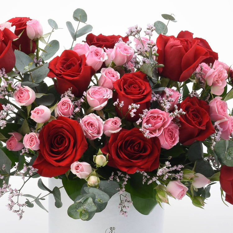 Vibrant red and pink roses with eucalyptus and baby&
