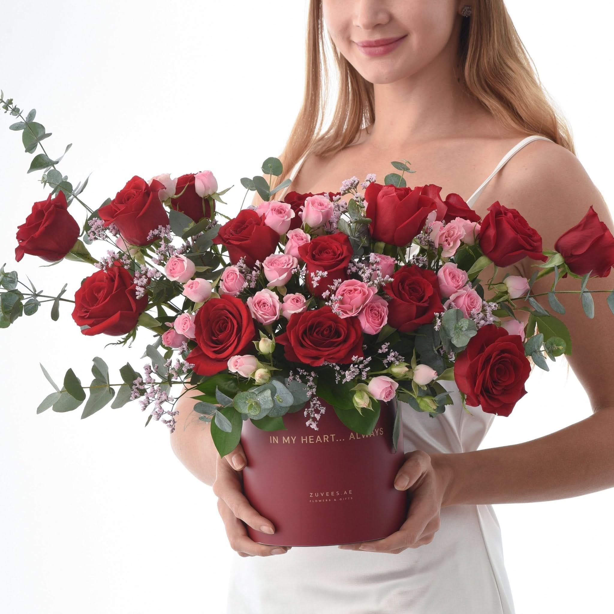 Vibrant red and pink roses in a maroon box with "In My Heart... Always" text.