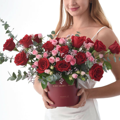 Vibrant red and pink roses in a maroon box with "In My Heart... Always" text.