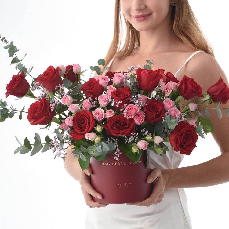 Vibrant red and pink roses in a maroon box with "In My Heart... Always" text.