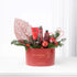 Vibrant red holiday gift basket with festive decor and Rituals skincare.