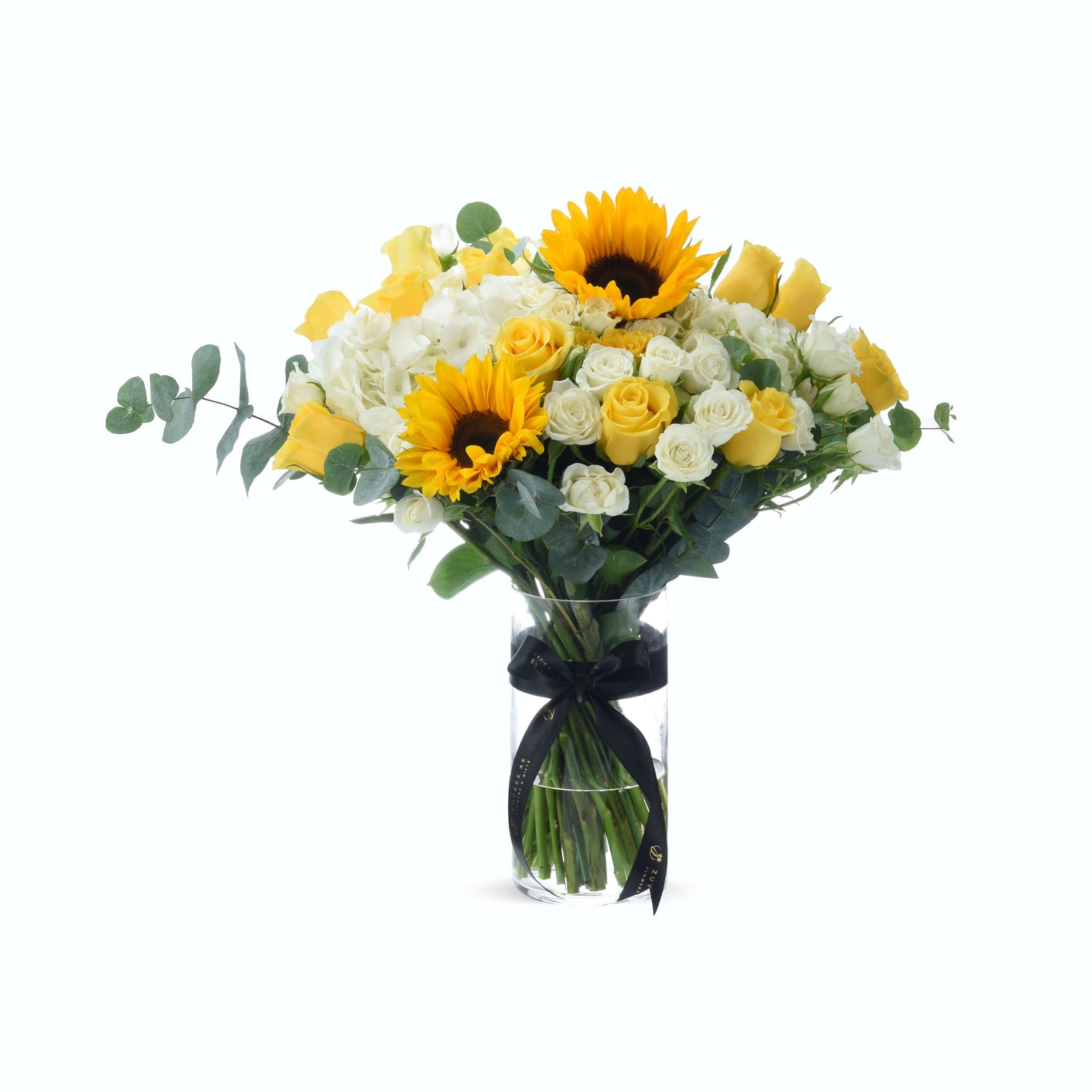 Vibrant yellow sunflowers and roses in clear vase with elegant black ribbon.