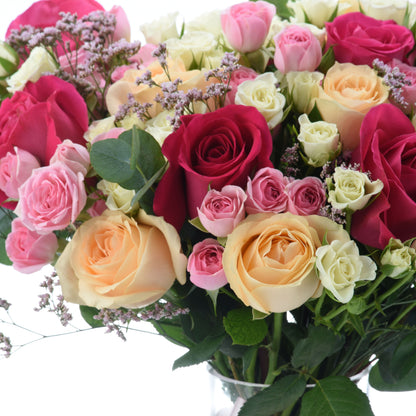 Vibrant multicolor roses in lush bouquet with delicate baby&