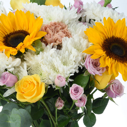 Vibrant sunflowers, roses, and chrysanthemums in yellow, pink, and white.