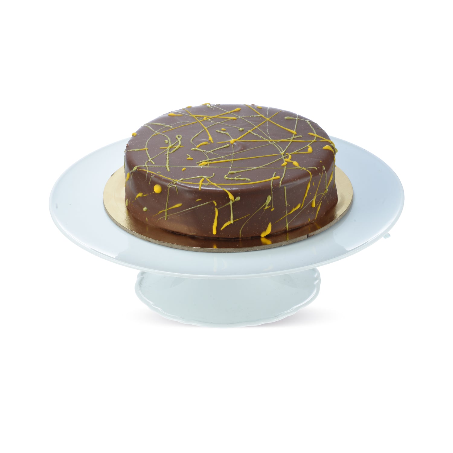 Rich chocolate cake with golden drizzle, elegantly presented on a white cake stand.