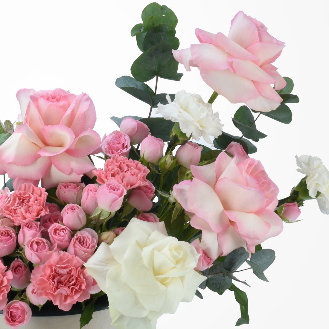 Soft pink and white roses with carnations and eucalyptus leaves.