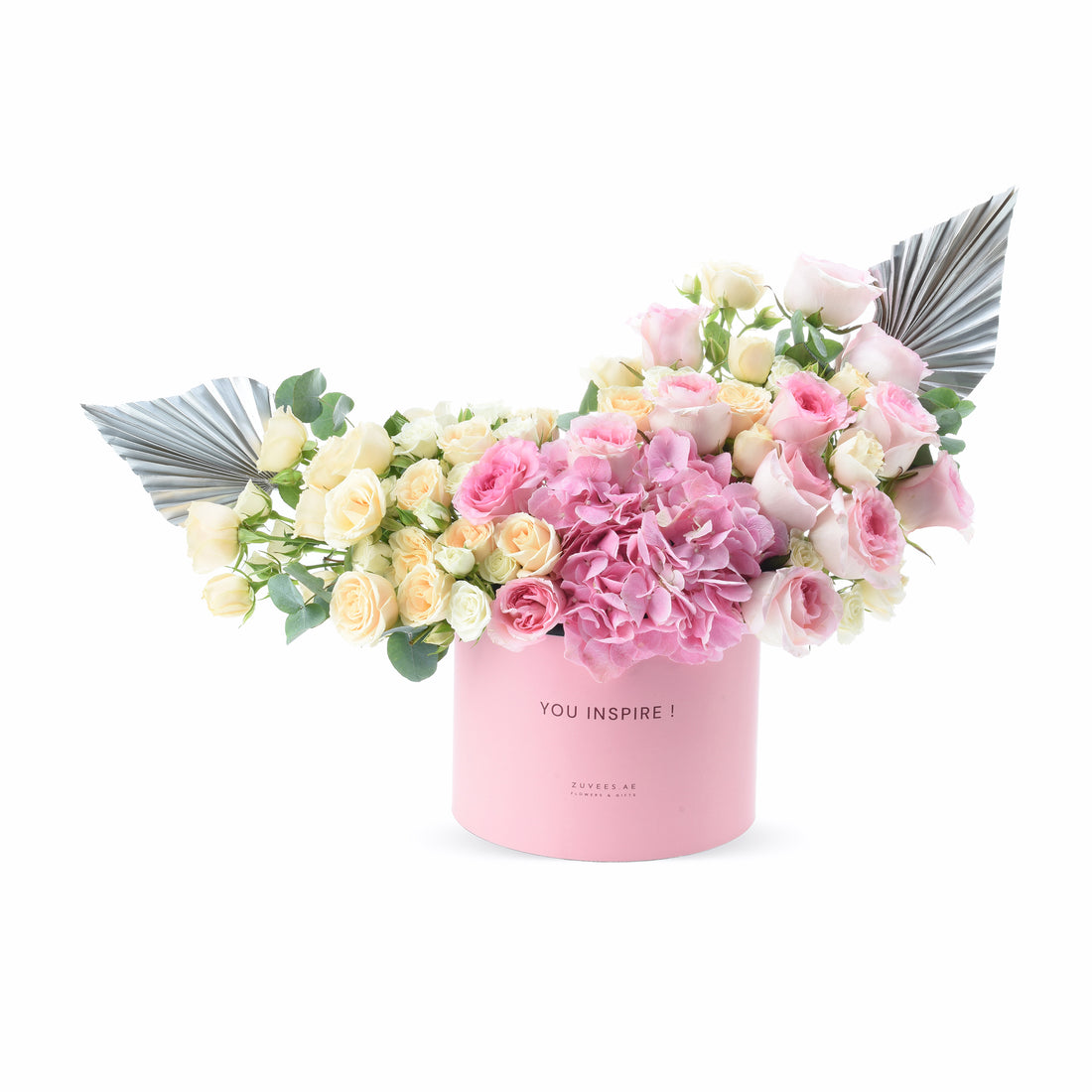 Pink box with roses, hydrangeas, silver leaves; "YOU INSPIRE!" text, elegant gift bouquet.