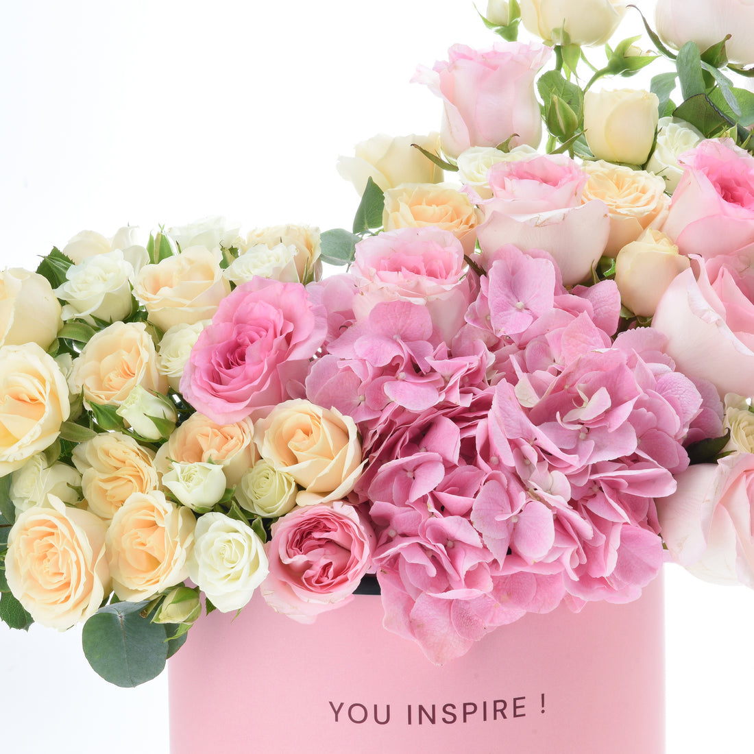 Pink hydrangeas, blush and cream roses in a soft pink "YOU INSPIRE!" gift box.