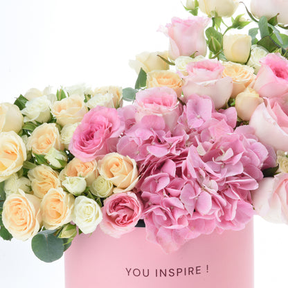Pink hydrangeas, blush and cream roses in a soft pink "YOU INSPIRE!" gift box.