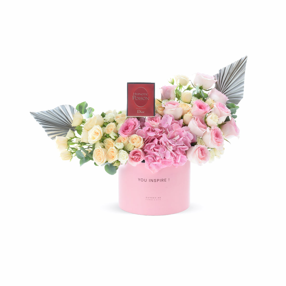 Pink box holds blush roses and hydrangeas, flanked by silver fans, topped with Dior perfume.