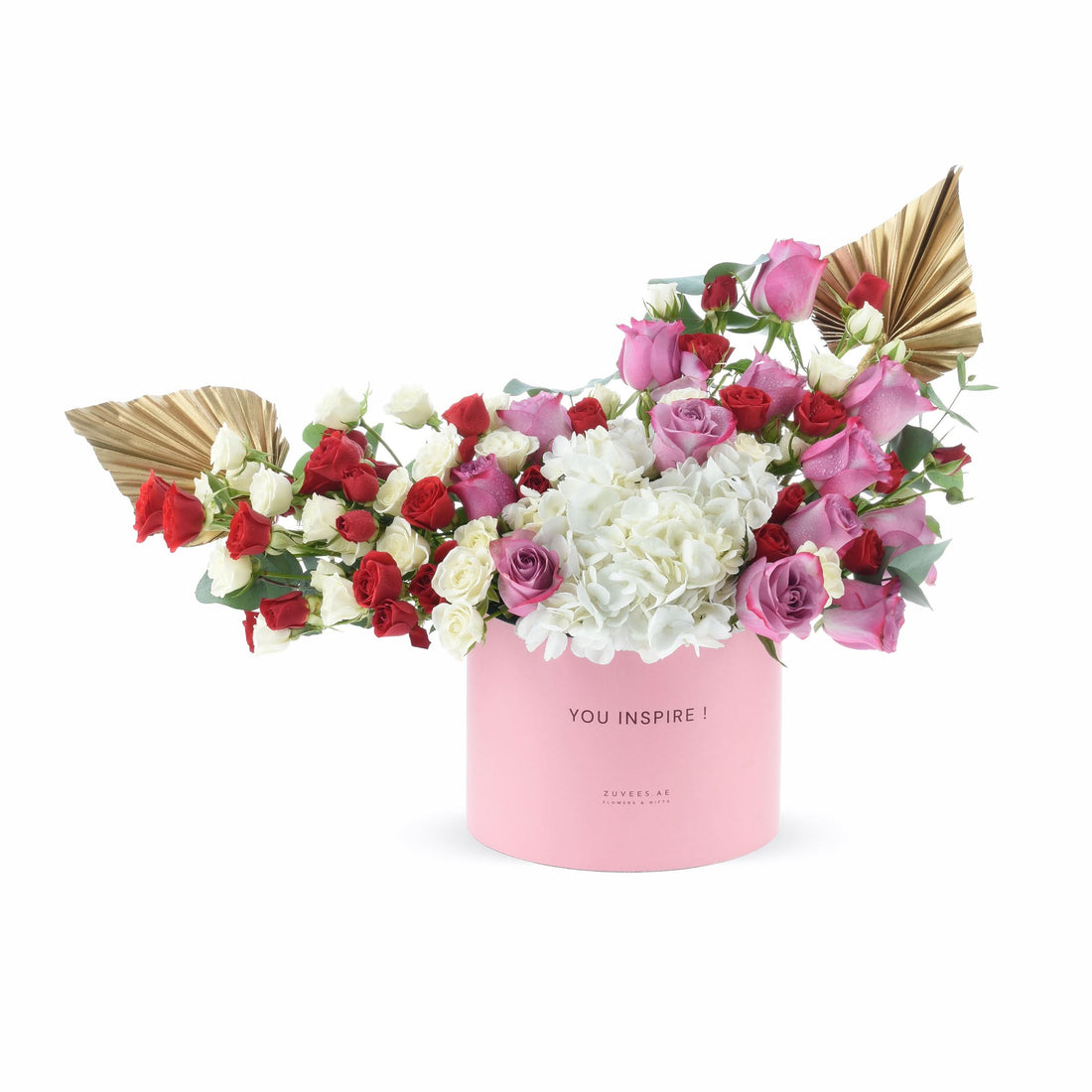 Pink box holds vibrant red, white, and pink roses with gold fan accents.