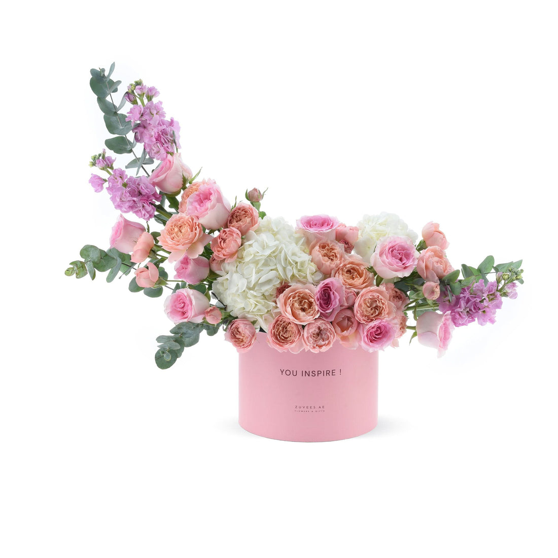 Pink box with "YOU INSPIRE!" text, holding pink roses, white hydrangeas, and green eucalyptus.
