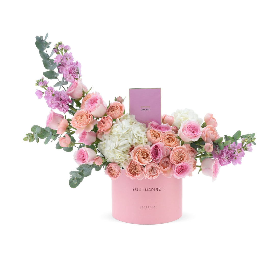 Pink floral arrangement in branded box with Chanel perfume.