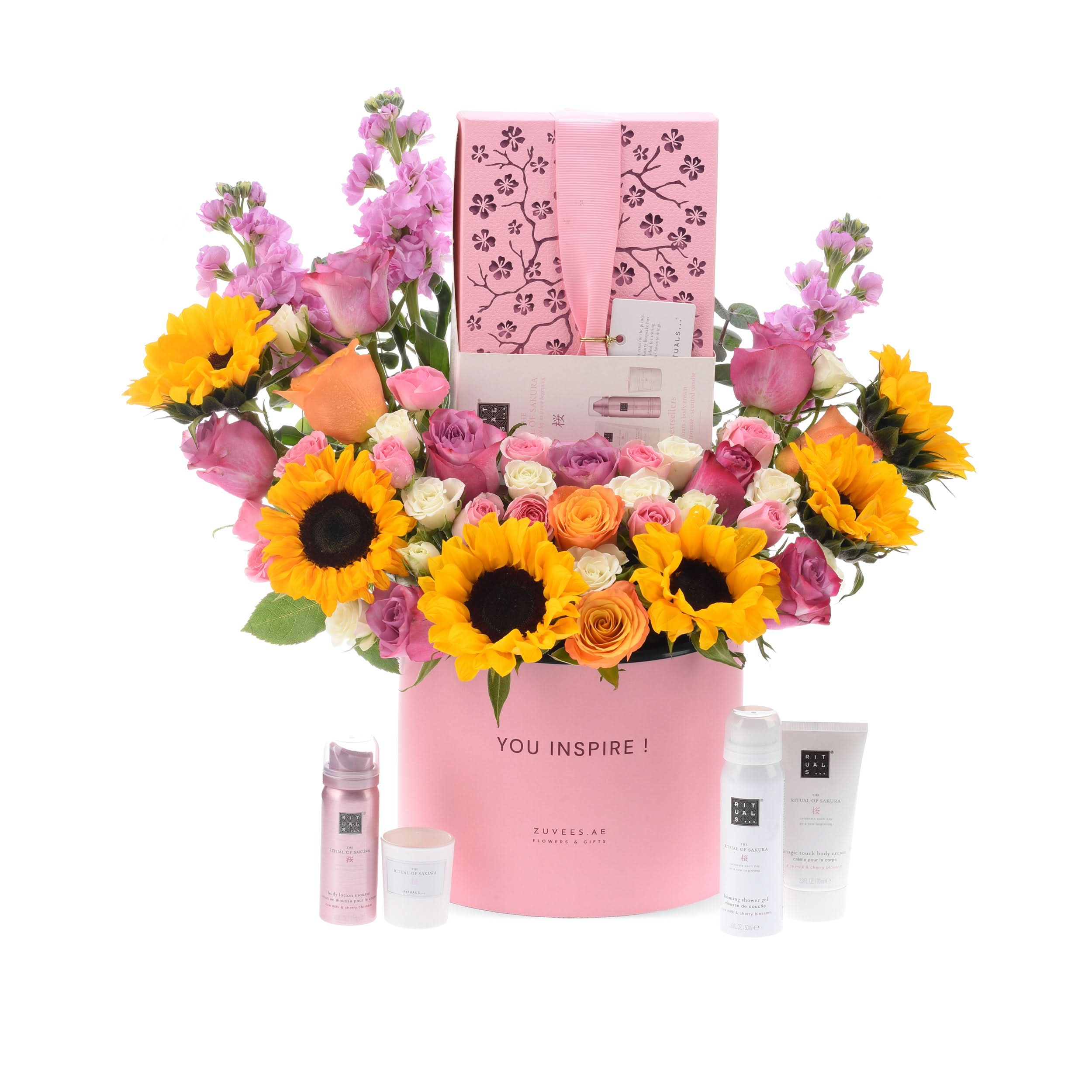 Pink floral gift set with sunflowers, roses, and Rituals skincare.