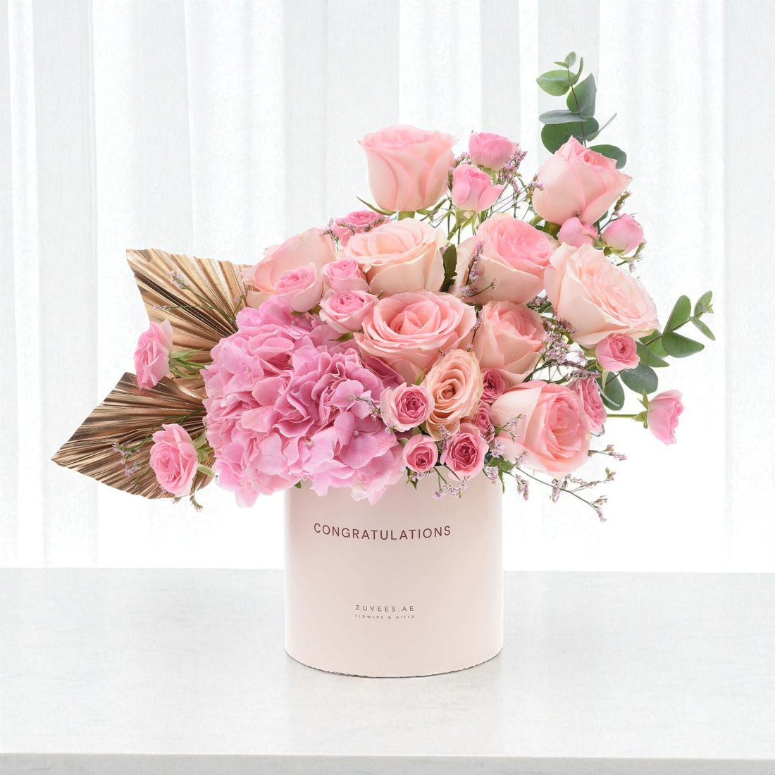 Soft pink roses and hydrangeas in "Congratulations" box with gold leaf accent.