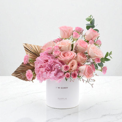 Soft pink roses and hydrangeas in white box with "I&