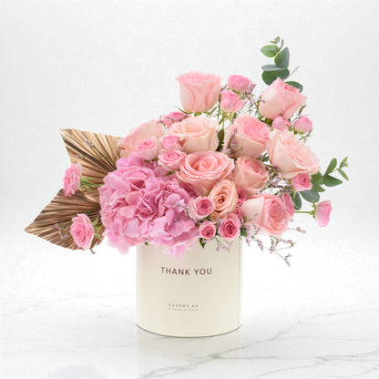 Soft pink roses and hydrangeas in cream box with "Thank You" text.