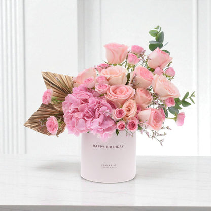 Soft pink roses and hydrangeas in a "Happy Birthday" box with gold leaf accent.