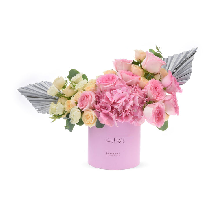 Soft pink roses and hydrangeas in lavender box with metallic silver accents.