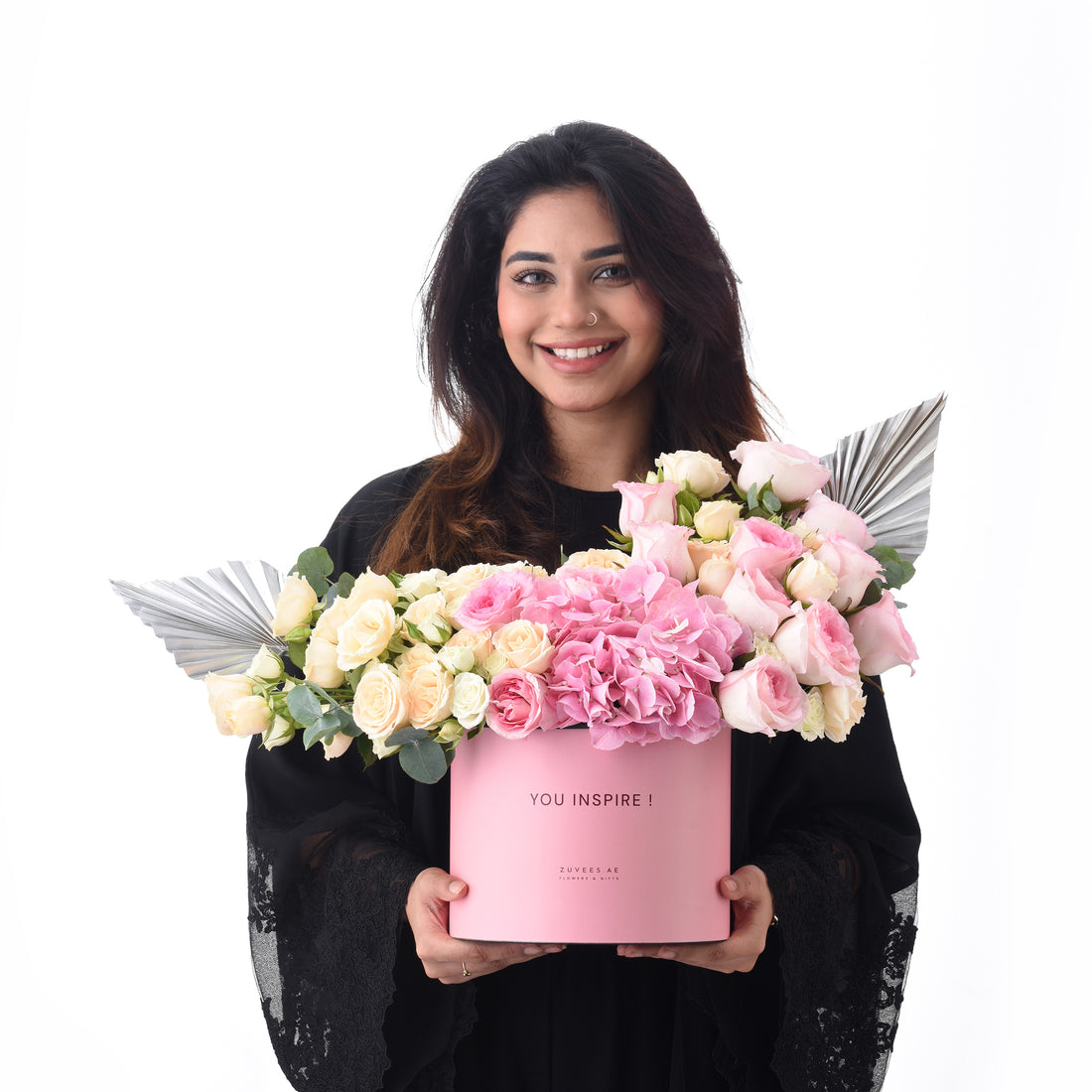 Pink box holds blush roses and hydrangeas, accented with silver fan wings.