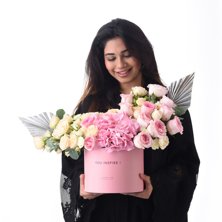 Pink box holds roses and hydrangeas, silver accents, "You Inspire!" text.