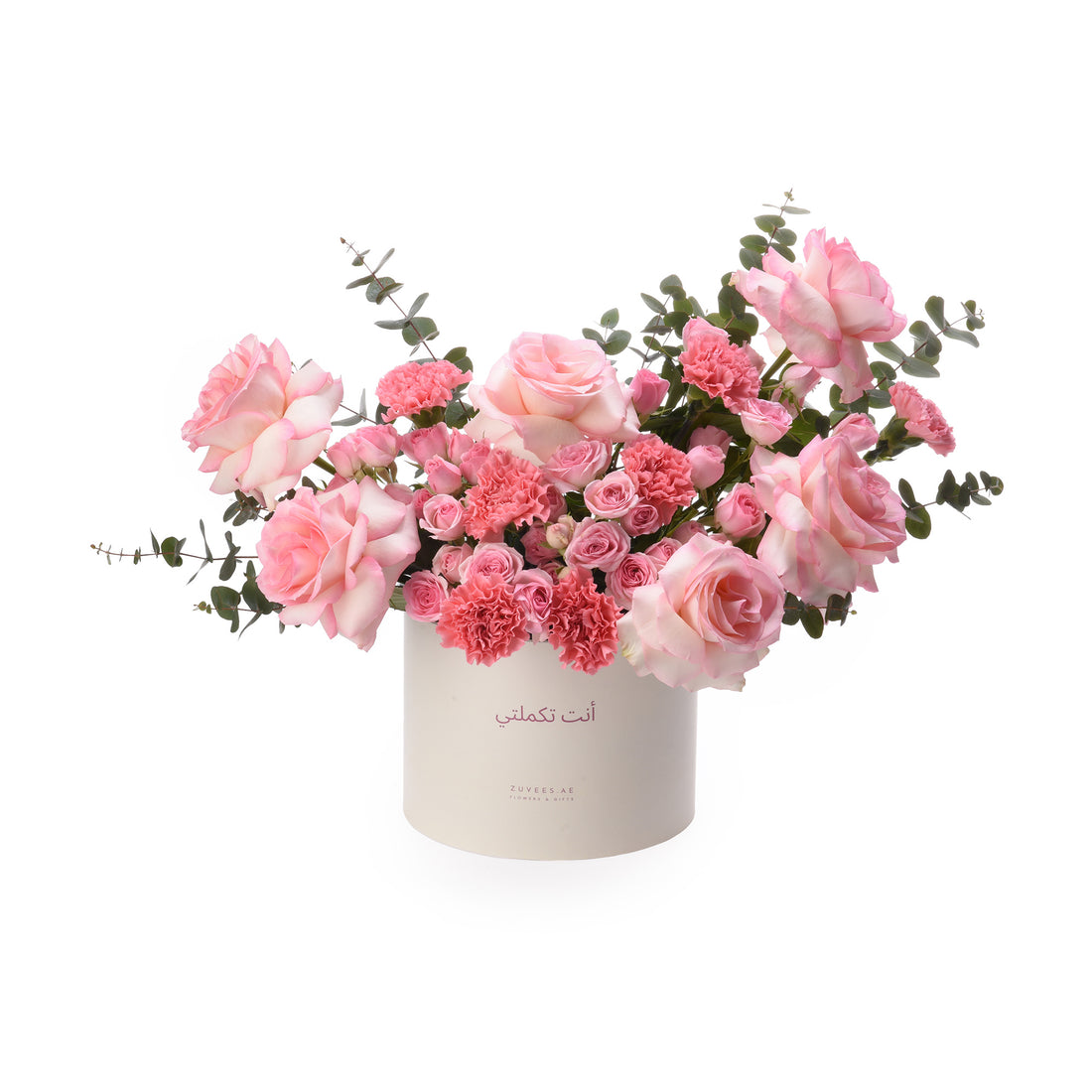 Soft pink roses and carnations in elegant white box with Arabic script.