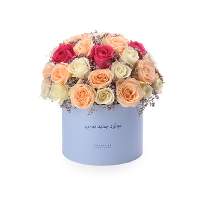 Pastel-hued roses in lavender box, Arabic birthday greeting.