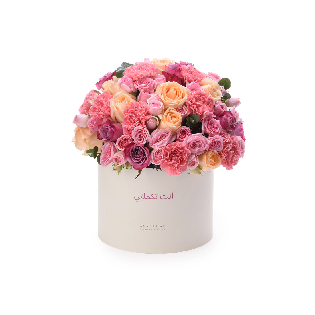 Cream box overflowing with vibrant pink, peach, and magenta roses and carnations.