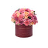 Vibrant pink, peach, and magenta roses and carnations overflowing from a deep burgundy hat box with gold "IN MY HEART... ALWAYS" text.
