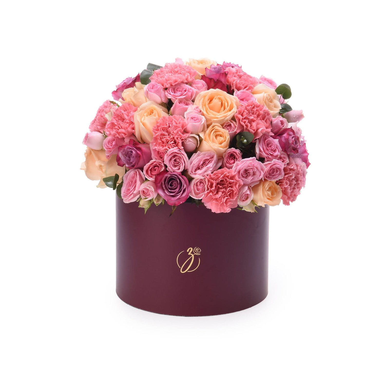Luxurious burgundy hat box overflowing with vibrant pink, peach, and magenta roses and carnations.