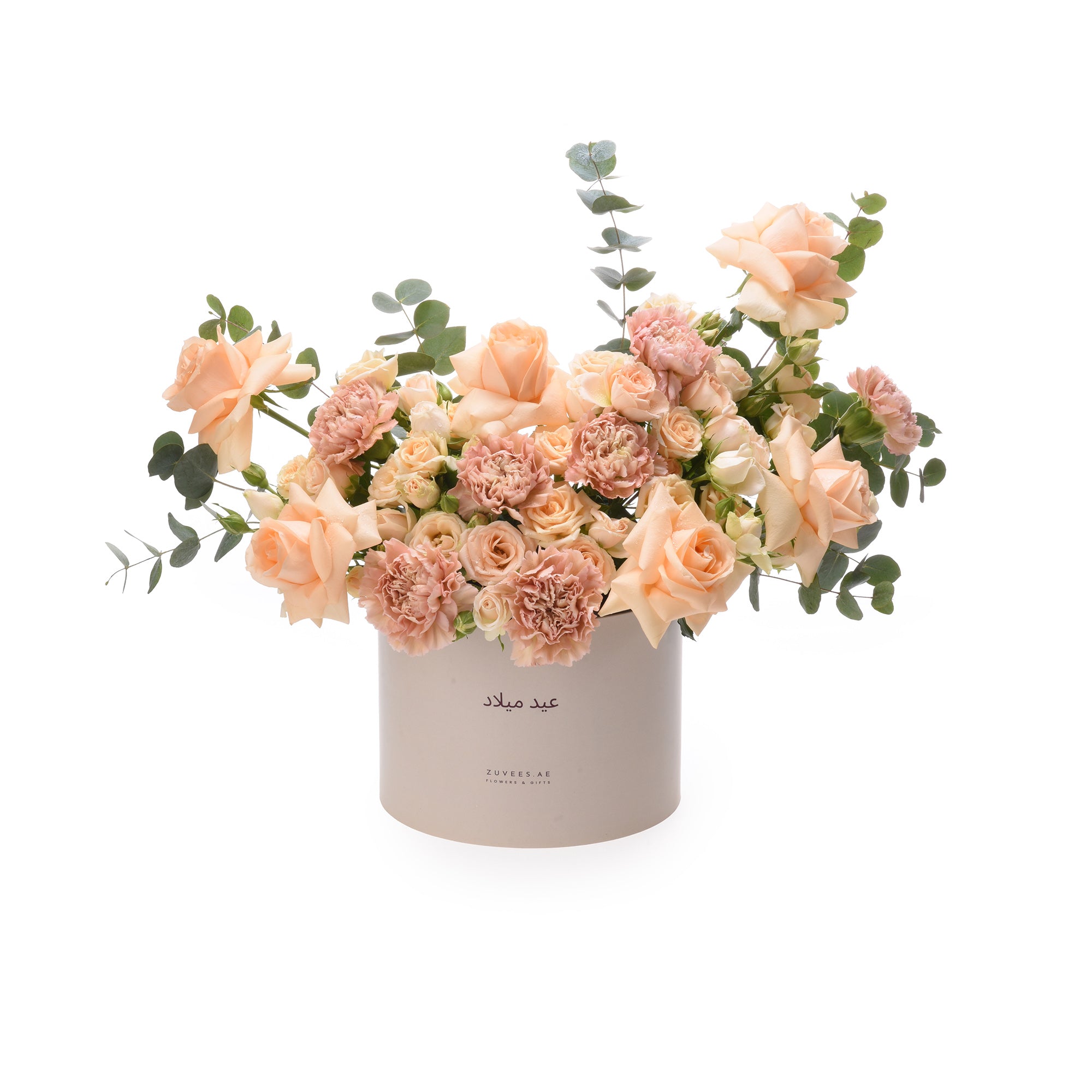 Soft peach roses and carnations in elegant beige cylindrical box.